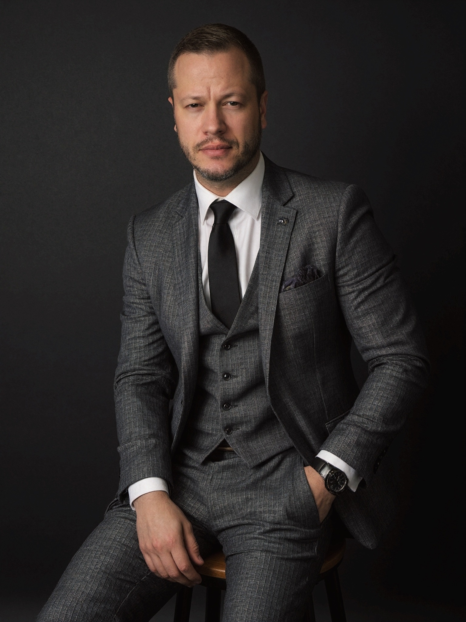 Hunter J. Aldridge in a charcoal three-piece suit